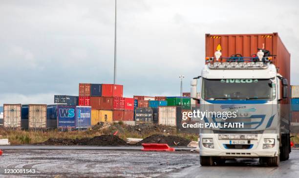 Stacked containers are pictured in the Belfast Harbour and docks area in Northern Ireland on December 10, 2020. - The port is Northern Ireland's main...