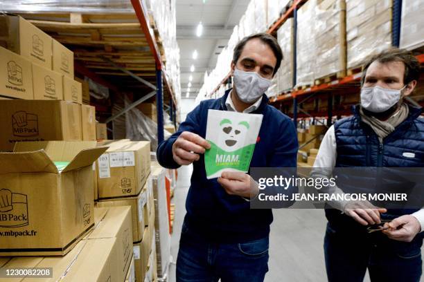 Laurent Lemarchand and Claude Daniel, managing partners of MB Pack holds a box in the warehouse of their company, specialised in food packaging, in...