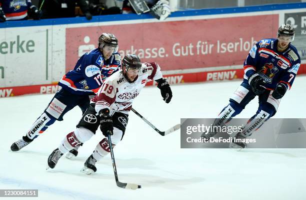 Tim Fleischer of Iserlohn Roosters and Jason Akeson of Koelner Haie battle for the puck during the Ice Hockey Test Match between Iserlohn Roosters...