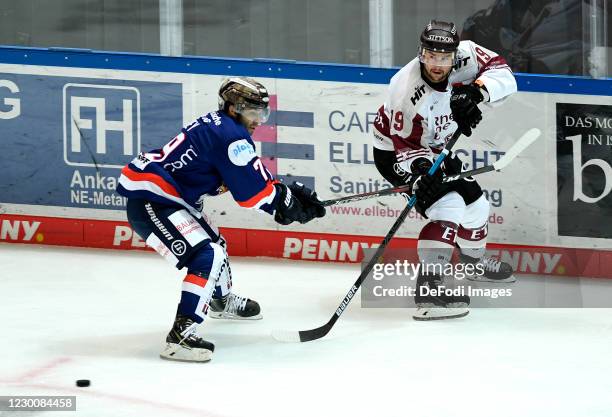 Joe Whitney of Iserlohn Roosters and Jason Akeson of Koelner Haie battle for the puck during the Ice Hockey Test Match between Iserlohn Roosters and...