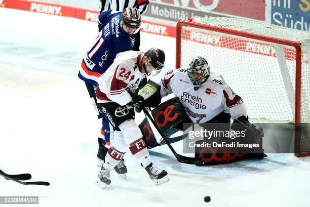 Brody Sutter of Iserlohn Roosters and Zachery Sill of Koelner Haie battle for the puck during the Ice Hockey Test Match between Iserlohn Roosters and...