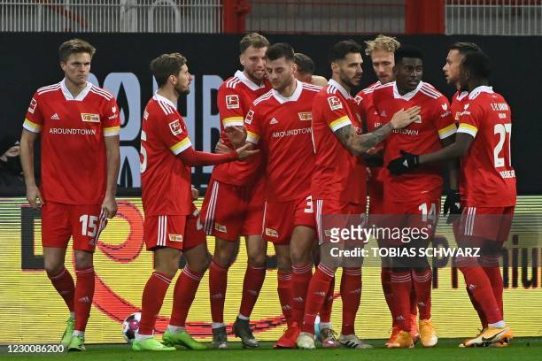 Union Berlin's German midfielder Grischa Proemel celebrates scoring the opening goal with his teammates during the German first division Bundesliga...