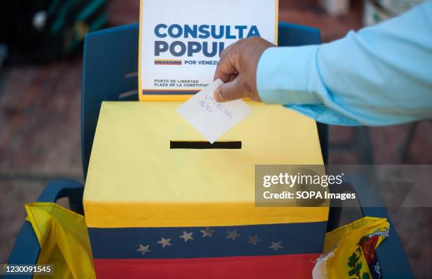 Venezuelan resident casting his vote during the referendum. Led and promoted by opposition leader, Juan Guaido, a popular referendum was held at...