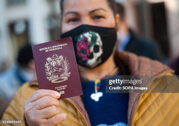 Venezuelan resident showing off her passport during the referendum. Led and promoted by opposition leader, Juan Guaido, a popular referendum was held...