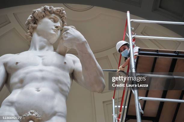 Restorer cleans Michelangelo's David statue while preparing for the reopening of the Galleria dell'Accademia which was closed for almost three months...