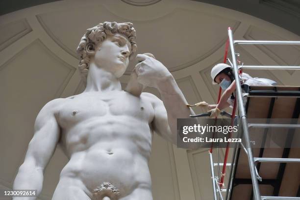 Restorer cleans Michelangelo's David statue while preparing for the reopening of the Galleria dell'Accademia which was closed for almost three months...