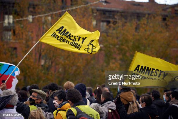 Flags of the NGO Amnesty International. Thousands protesters marched again against the 'Global Security Law' bill promoted by French President Macron...