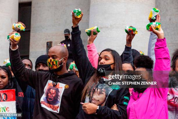 Casey Goodson Jr.'s family and attorney, Sean Walton , raise subway sandwiches during a protest for Casey Goodson Jr. In front of the Ohio Statehouse...