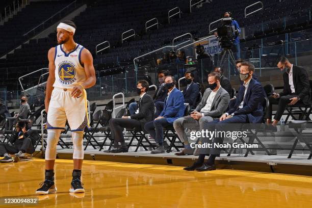 Stephen Curry of the Golden State Warriors looks while in front of the ownership group during a preseason game against the Denver Nuggetson December...