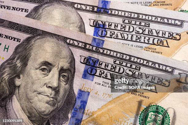 In this photo illustration, a portrait of Benjamin Franklin seen displayed on a 100-dollar bill.