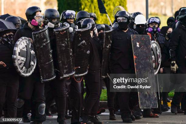 Anti-fascist protesters watch supporters of President Donald Trump during political clashes on December 12, 2020 in Olympia, Washington. Far-right...