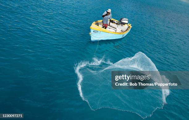 Local fisherman Melbourne Richards casting his fishing net in the Caribbean Sea near Bridgetown, on the West coast of Barbados, 19th November 2018.