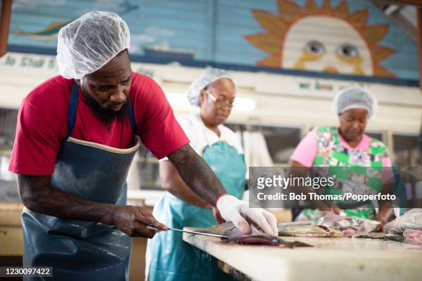 Darrin Harewood, Jemma Harris, and Juliette Sobers working in the fish market at Bridgetown, Barbados, 19th November 2018.