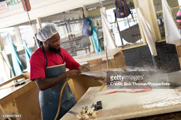 Darrin Harewood working in the fish market at Bridgetown, Barbados, 19th November 2018.