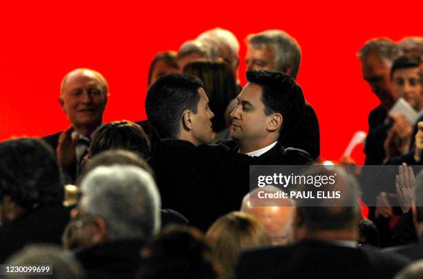 Former British climate change minister Ed Miliband embraces his brother, the former Foreign Secretary David Miliband, after being elected new leader...