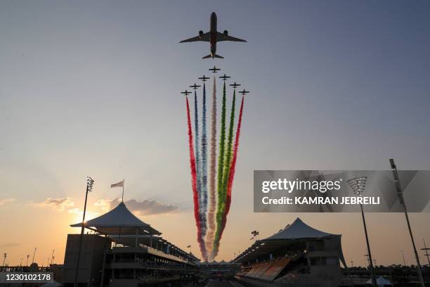 An Etihad Boeing 787-9 "Dreamliner" jet flies over the circuit ahead of the Abu Dhabi Formula One Grand Prix at the Yas Marina Circuit in the Emirati...