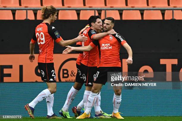 Lorient's French midfielder Quention Boisgard is congratulated by teammates after scoring a goal during the French L1 football match between FC...