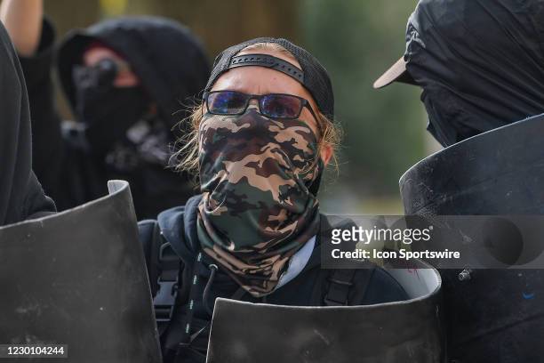 An Antifa member stands behind a riot shield during a Stop The Steal protest at the Georgia State Capitol on December 12th, 2020 in Atlanta, GA.