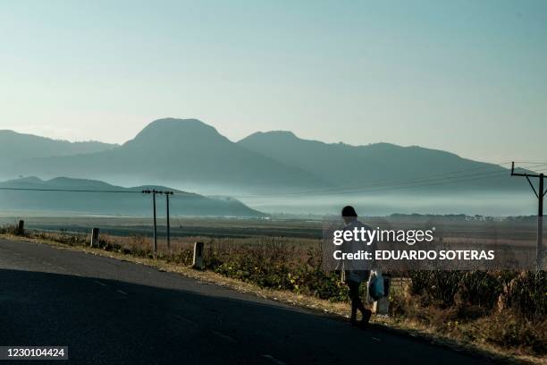 Youngster walks on the side of the road in a rural area in Amhara region, Ethiopia, on December 13, 2020.