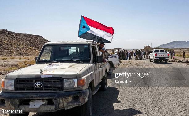 Fighters loyal to Yemen's separatist Southern Transitional Council travel in a convoy in Yemen's southern Abyan province, on December 13 as part of a...