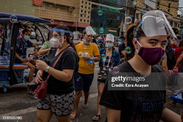 Shoppers wearing facemasks and face shields to protect against COVID-19 crowd Divisoria market on December 13, 2020 in Manila, Philippines. The...