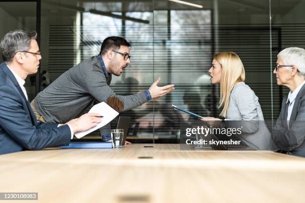 young couple arguing on a meeting with their lawyers in the office. - lawyers arguing stock pictures, royalty-free photos & images