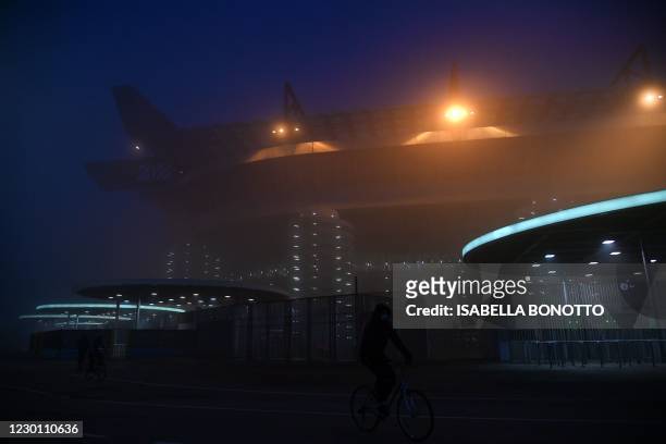 General view shows the San Siro stadium in the haze prior to the Italian Serie A football match AC Milan vs Parma on December 13, 2020 in Milan.