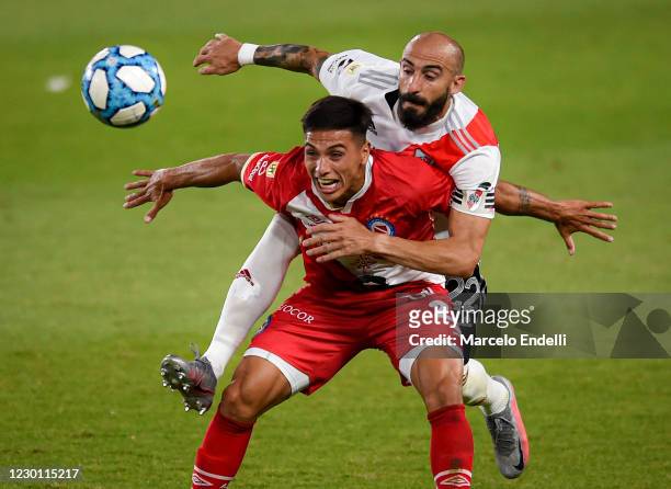 Javier Pinola of River Plate fights for the ball with Mateo Coronel of Argentinos Juniors during a match between River Plate and Argentinos Juniors...