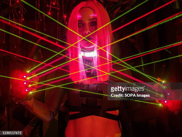 Cosplay girl demonstrates the capabilities of her costume at the Cyberpunk Festival. Russian gaming enthusiasts dress up as video game characters of...