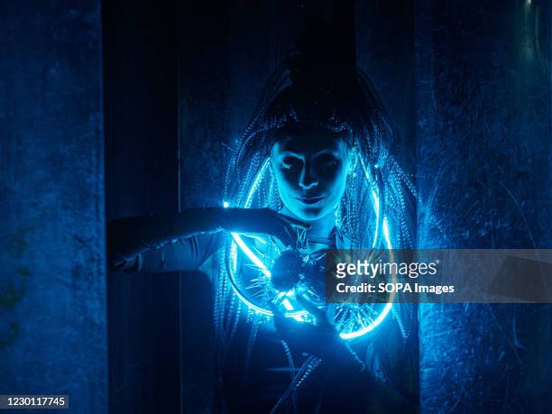 Cosplay girl in a futuristic luminous costume at the Cyberpunk Festival. Russian gaming enthusiasts dress up as video game characters of the...