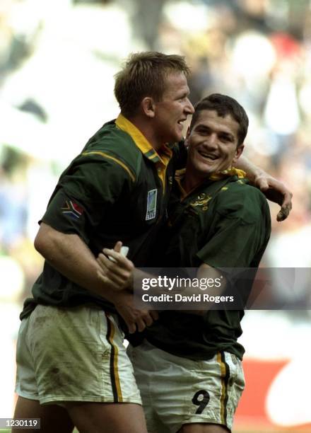 Joost van der Westhuizen and Andre Venter of South Africa celebrate victory in the Rugby World Cup quarter-final match against England at the Stade...