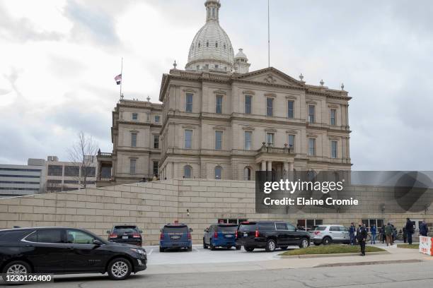 Governor Gretchen Whitmer is escorted to the entrance of the Michigan State Capitol on December 14, 2020 in Lansing, Michigan. Michigan electors will...