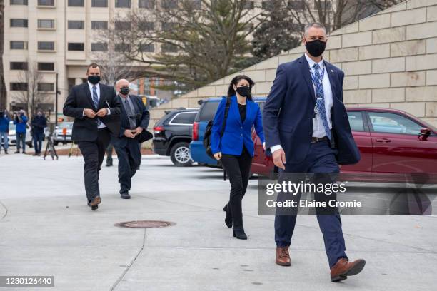 Attorney General of Michigan Dana Nessel, center, is escorted to the entrance of the Michigan State Capitol on December 14, 2020 in Lansing,...