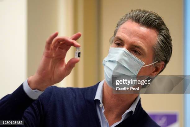 Gov. Gavin Newsom holds up a vial of the Pfizer-BioNTech COVID-19 vaccine at Kaiser Permanente Los Angeles Medical Center on December 14, 2020 in Los...