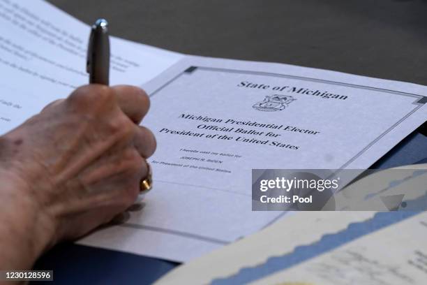 Electoral College elector Bobbie Walton signs her ballot for President of the United States at the state Capitol on December 14, 2020 in Lansing,...