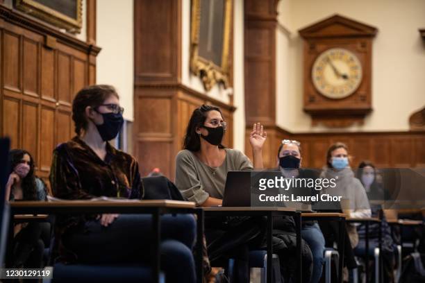Masked students sit in a socially distanced class in the Examination Schools of the University of Oxford on November 24, 2020 in Oxford, England. The...