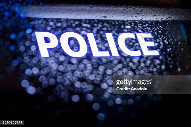 Police car logo is seen as French police officers demonstrate in front of the Arc de Triomphe on Place de l'Etoile in Paris on December 14 over their...