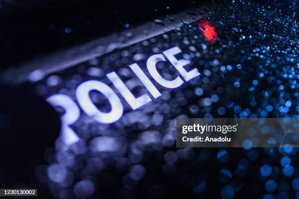 Police car logo is seen as French police officers demonstrate in front of the Arc de Triomphe on Place de l'Etoile in Paris on December 14 over their...