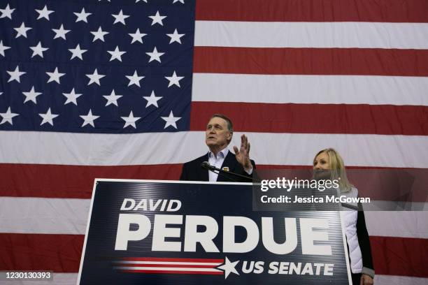 Sen. David Perdue and his wife, Bonnie, address the crowd during a campaign rally at Peachtree Dekalb Airport on December 14, 2020 in Atlanta,...