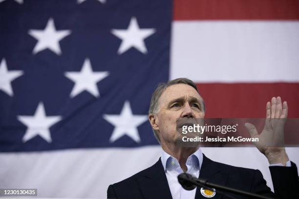 Sen. David Perdue addresses the crowd during a campaign rally at Peachtree Dekalb Airport on December 14, 2020 in Atlanta, Georgia. As early voting...