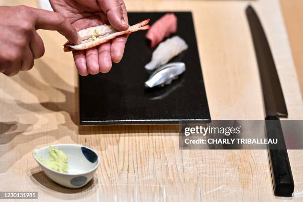 In this picture taken on December 1 Japanese sushi master Toshiya Matsushita spreads fresh wasabi on a shrimp at his restaurant in Tokyo. - If you've...