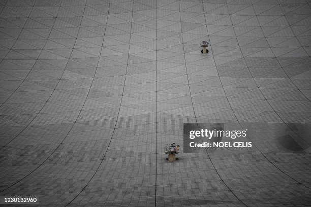 This photo taken on December 13 the Five-hundred-meter Aperture Spherical radio Telescope undergoes maintenance at the National Astronomical...