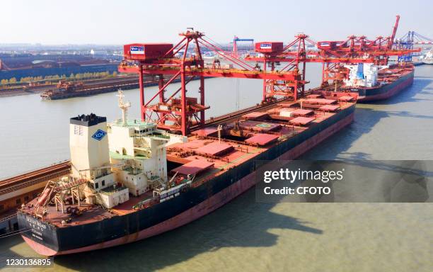 Aerial photo taken on December 9, 2020 shows a ship unloader unloading iron ore imported from Australia at an iron ore operation terminal in Taicang...