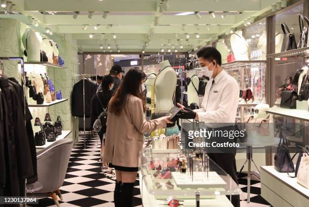 Shoppers shop at a tax-free plaza in Haikou, South China's Hainan Province, Dec. 15, 2020. Duty-free shopping has become a tourist attraction in...
