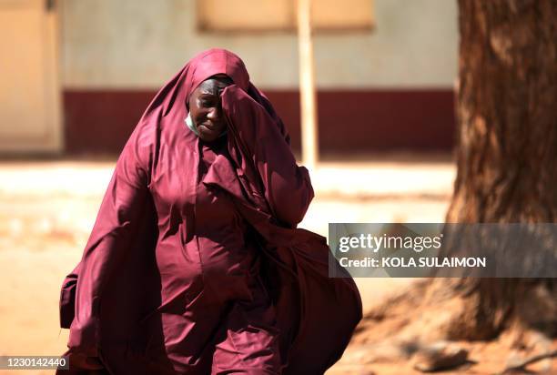 Woman whose son was abducted reacts inside the Government Science where gunmen abducted students in Kankara, in northwestern Katsina state, Nigeria...