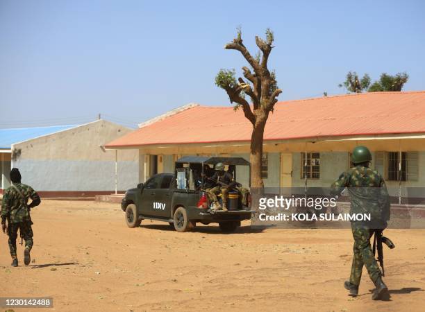 Nigerian soldiers walk inside the Government Science where gunmen abducted students in Kankara, in northwestern Katsina state, Nigeria December 15,...