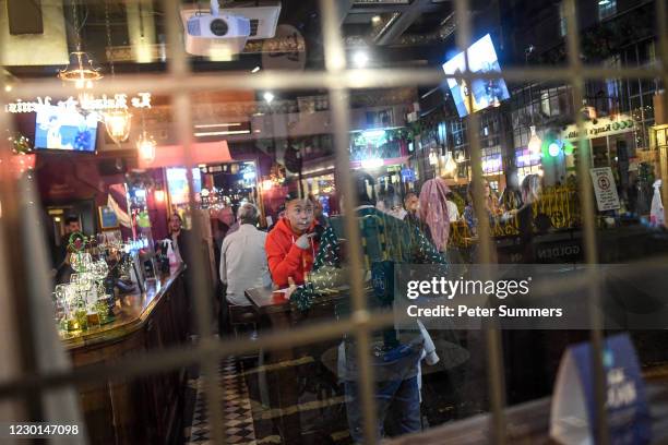 People are seen drinking in a pub in Soho, ahead of London being moved into Tier 3 of the pandemic-control system on Wednesday, on December 15, 2020...