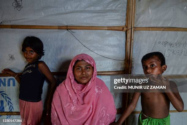 In this photograph taken on October 8 Rohingya refugee Arofa Khatun , who tried to migrate with her two children to Malaysia to her husband, poses...