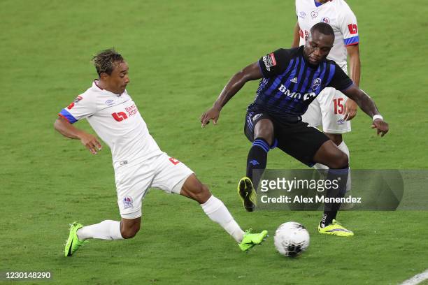 Javier Portillo of CD Olimpia competes for the ball against Zachary Brault-Guillard of Montreal Impact during the CONCACAF Champions League...