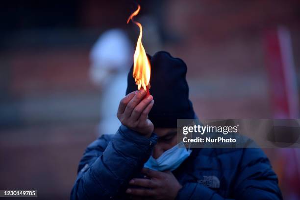 Nepalese devotees offering butter lamps in the premises after entering Pashupatinath Temple on Wednesday, December 16, 2020. Due to covid-19 pandemic...